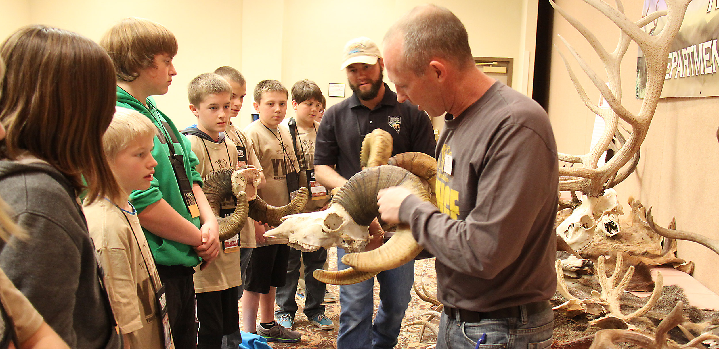 Ryan Brock explaining wild sheep annuli to a group of students
